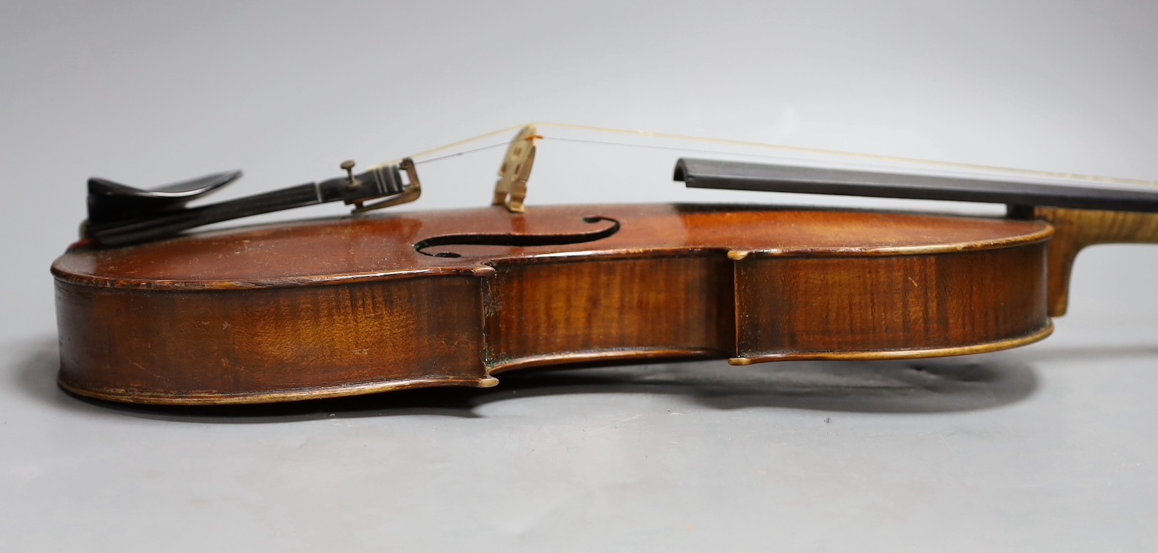 A cased late 19th century English violin, inscribed W. Heaton maker 1887 (?), back measures 35.5cm excl button